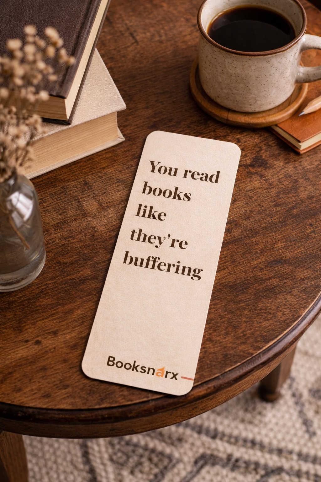 Bookmark on a wooden table with a cup of coffee and books in the background