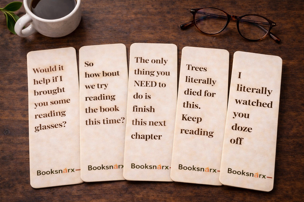 Five wooden bookmarks with humorous text on a wooden surface with a cup of coffee and glasses.